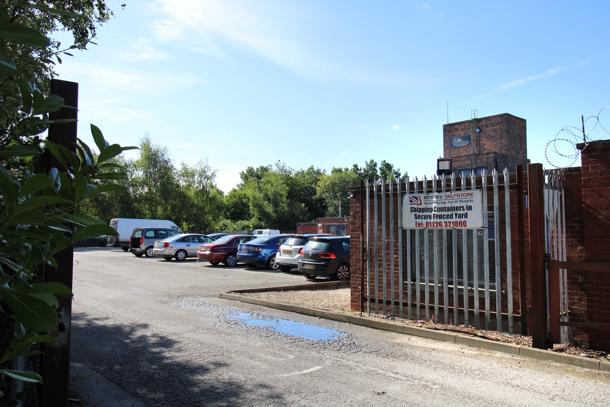 Entrance gates at Shireoaks Business Centre, with the brick tower visible beyond